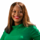 Smiling person in a green shirt against a white background.