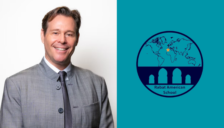 Person in a gray suit standing next to the Rabat American School logo featuring a map and architectural design elements.