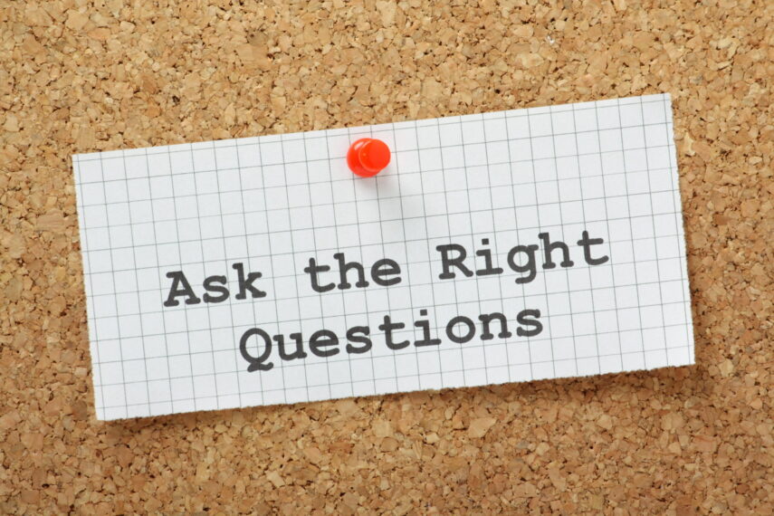 Note pinned on a corkboard with "Ask the Right Questions" written on it.